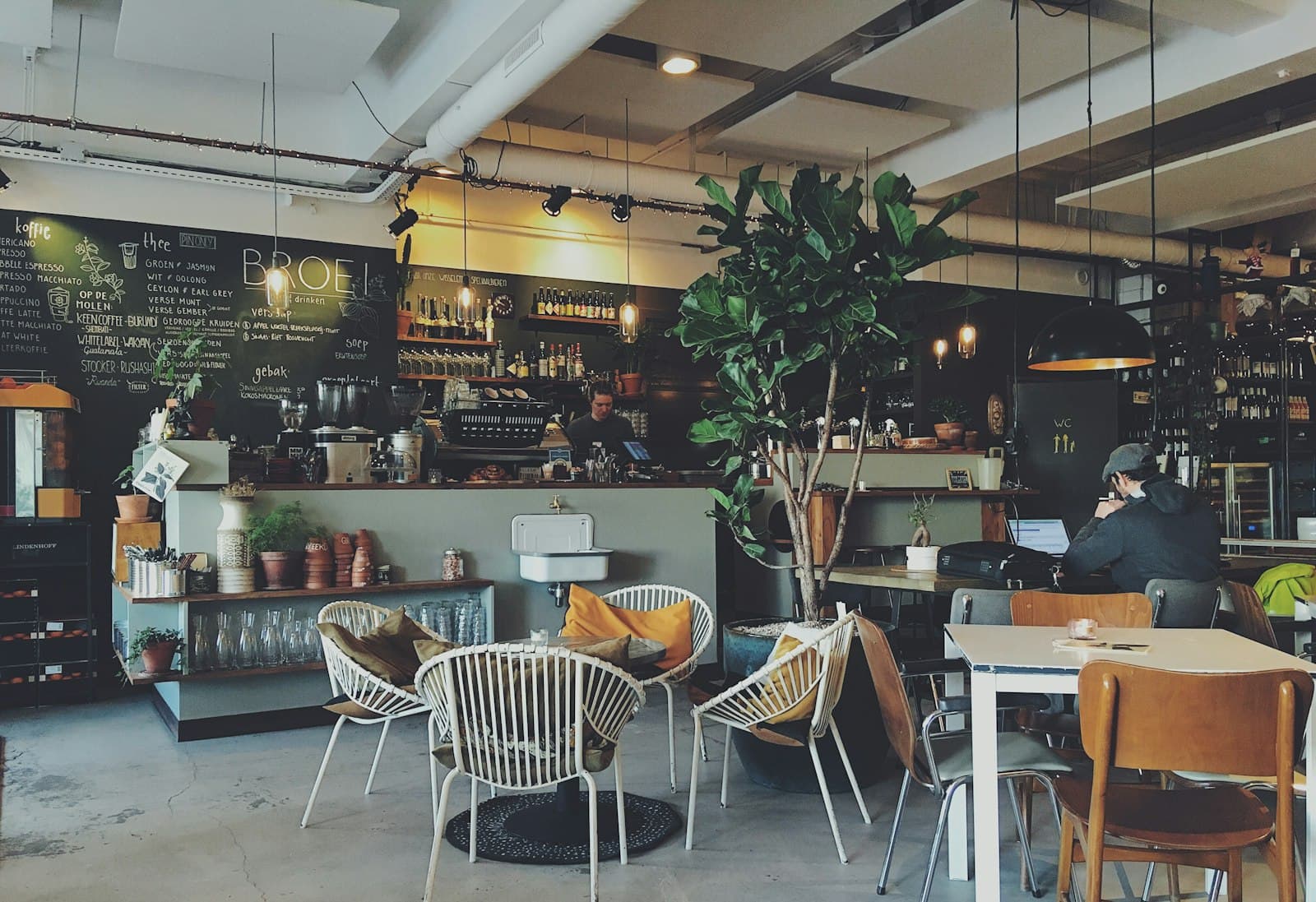 A busy independent café — staff at the counter, customers at tables